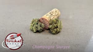 champagne slurpee buds next to cork and with the Rocket Cannabis logo